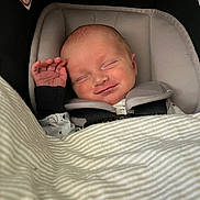 Layne joined the competition — help win amazing prizes! baby, newborn, car_seat, blanket, sleeping, smiling, infant, child, cozy, comfort, cute, face, hand, clothing, safety_belt, indoors, peaceful, resting, cute_expression, britax