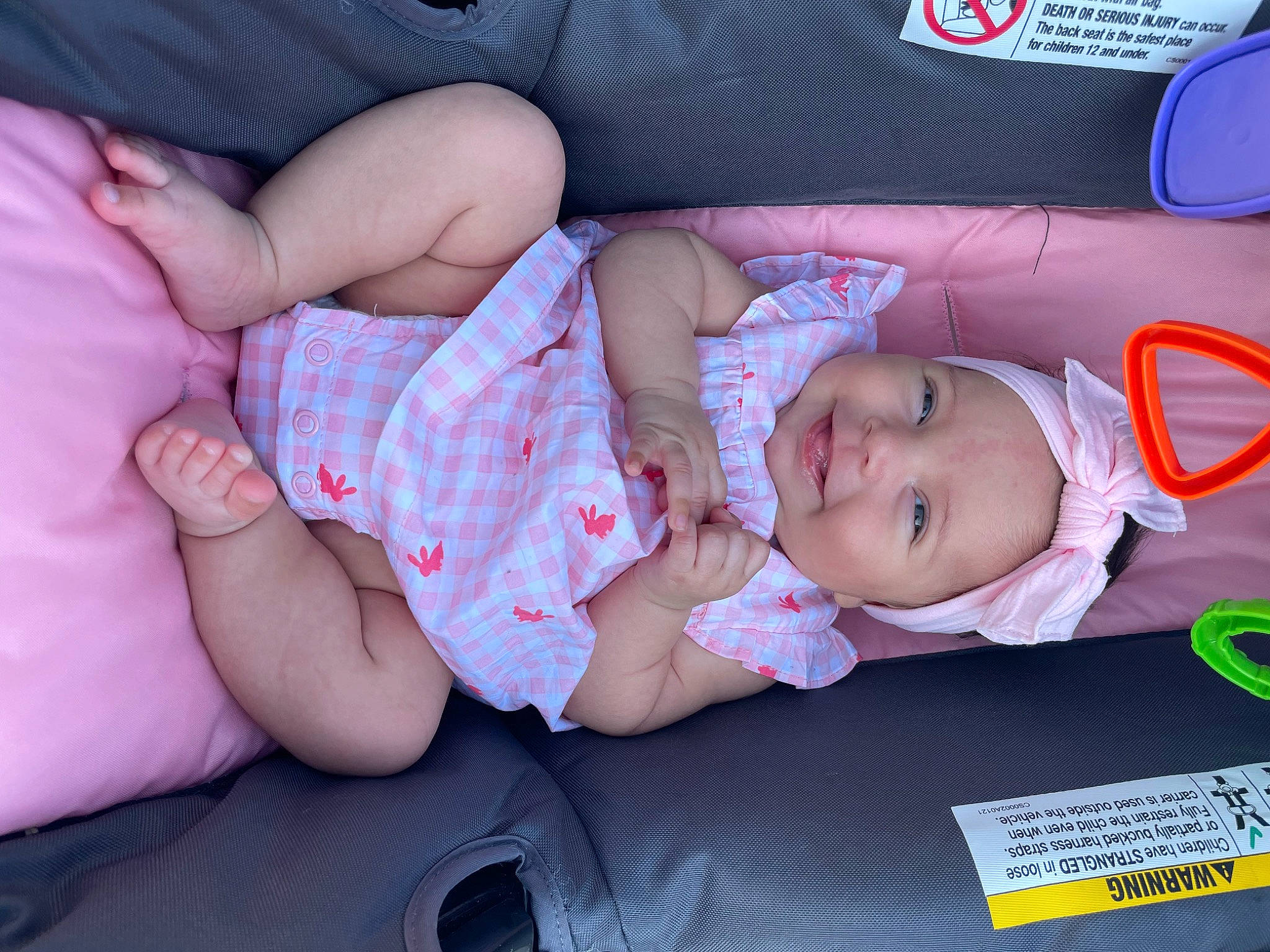 Charleigh is registered to the contest to win money with this photo: baby, baby_products, baby_toddler_clothing, cheek, child, comfort, facial_expression, finger, fun, gesture, headwear, human_body, human_leg, joy, lap, mouth, person, pink, sitting, skin