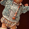 Lyla participe au concours pour gagner de l'argent avec cette photo : baby, pacifier, denim_jacket, headwrap, pink_shoes, heart_pattern, floral_bloomers, sock, cute, infant, child, fashion, portrait, indoor, posing, accessory, clothing, adorable, laying_down, young_child