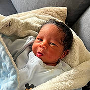 Kayssan participe au concours pour gagner de l'argent avec cette photo : newborn, baby, blanket, blue, clothing, couch, face, fur, fuzzy, infant, indoors, light, person, portrait, resting, skin, soft, toddler, tongue, warm