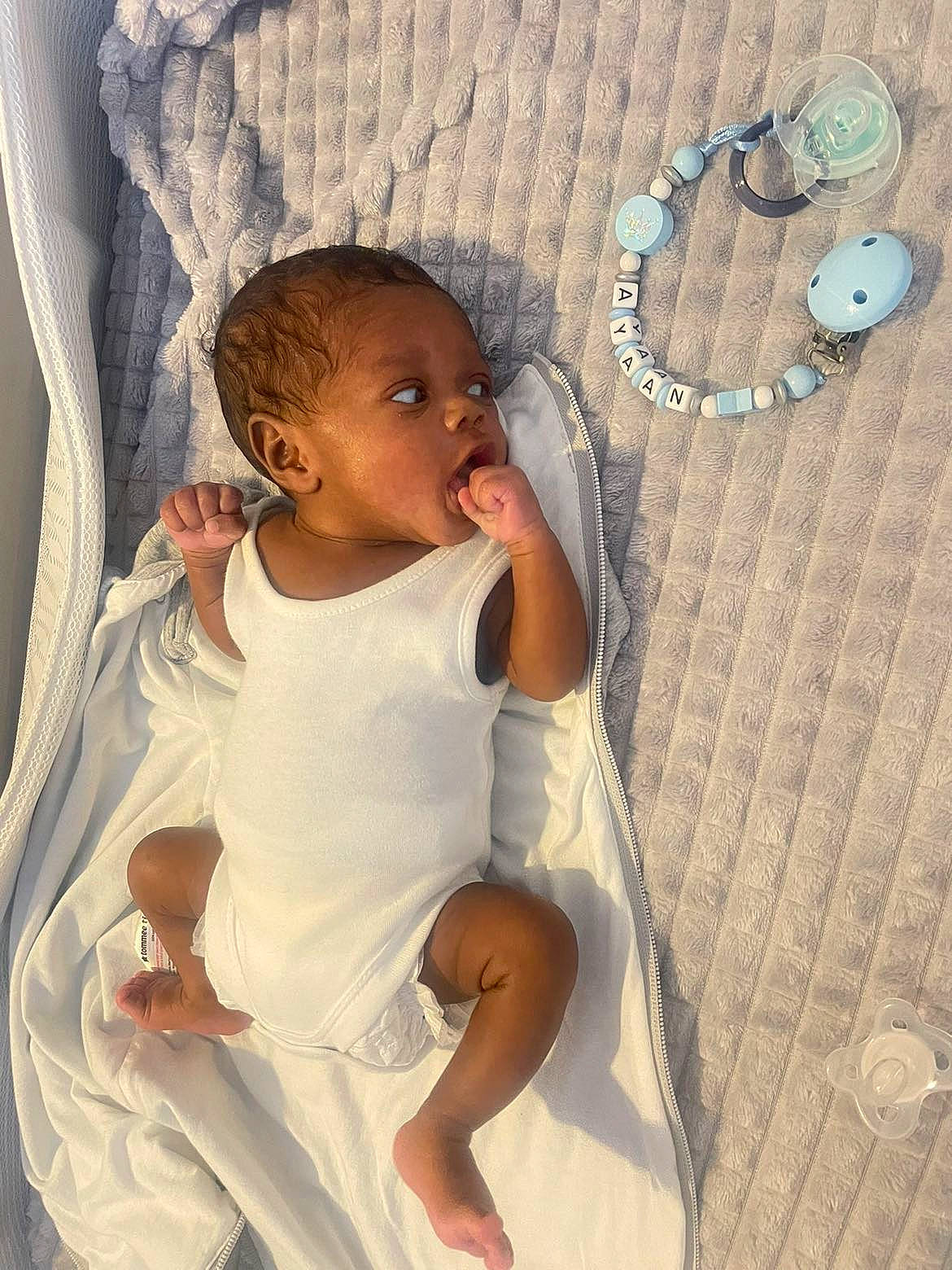 Ayaan is registered to the contest to win money with this photo: baby, baby_toddler_clothing, cheek, child, comfort, eye, face, fun, hairstyle, happy, head, human_body, linens, person, product, skin, sleeve, textile, thumb, toddler