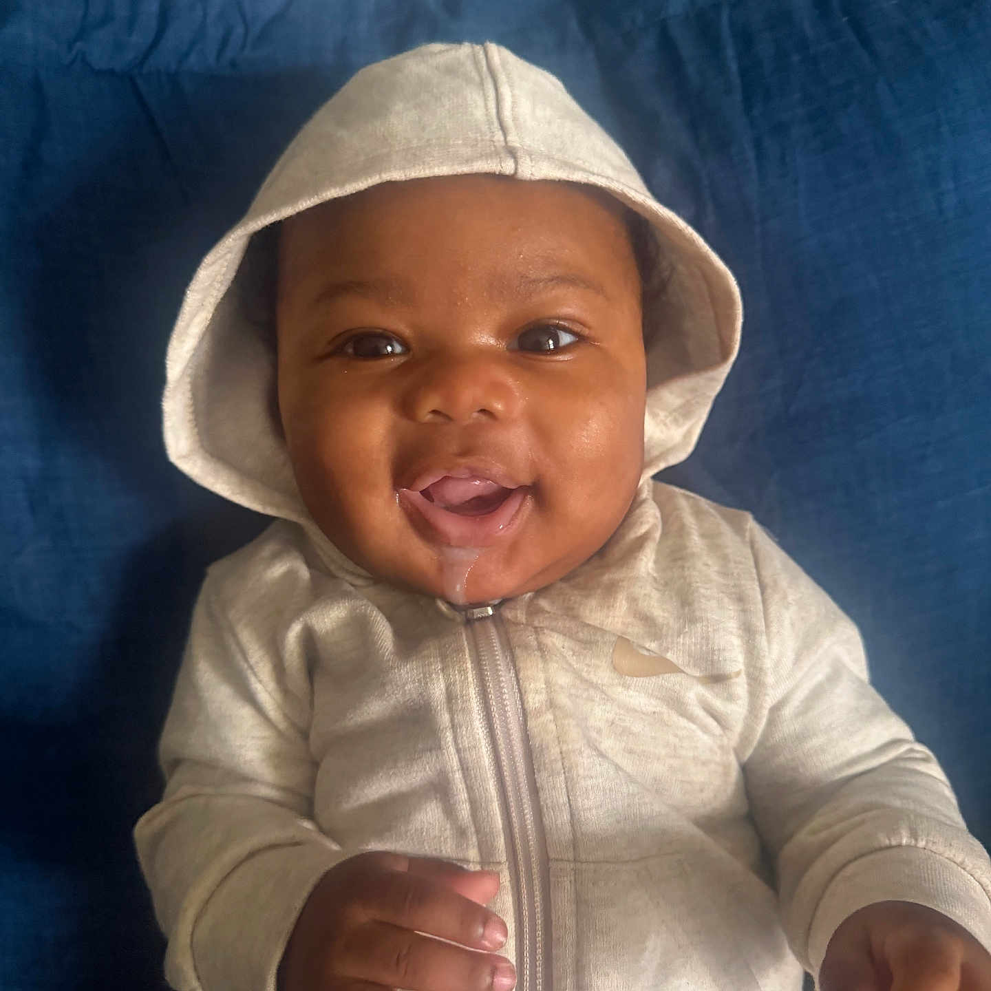 Davon joined the competition — help win amazing prizes! baby, hoodie, smile, drool, infant, child, cute, portrait, happy, clothing, sitting, indoor, person, cushion, blue, zipper, hand, face, headwear, closeup