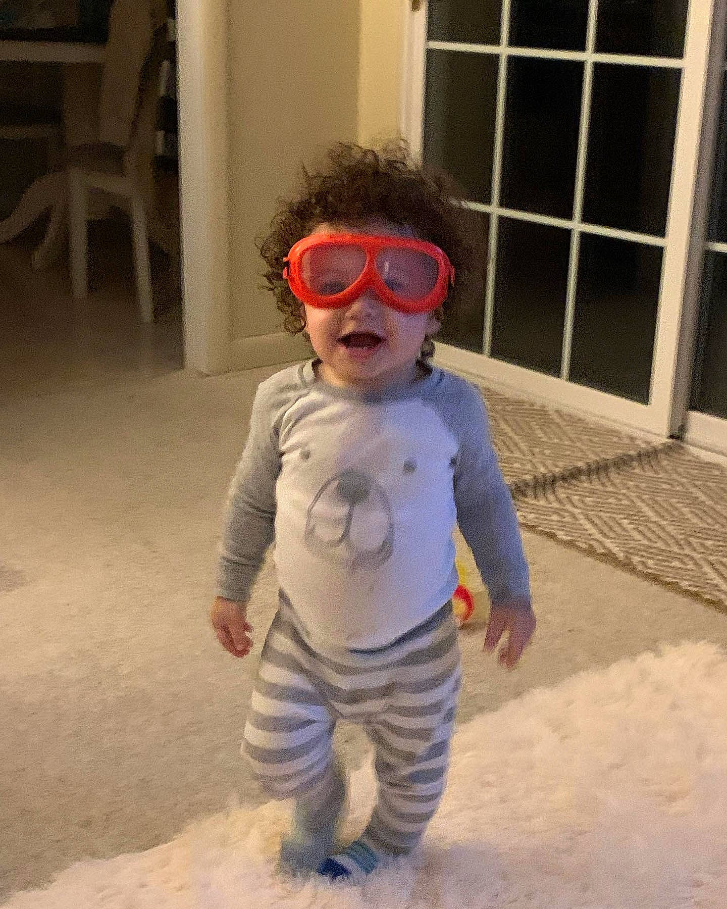 Bronson is registered to the contest to win money with this photo: baby, baby_toddler_clothing, chair, child, electric_blue, eyewear, fashion_design, flooring, fun, fur, glasses, goggles, happy, nose, person, personal_protective_equipment, sleeve, sunglasses, toddler, vision_care