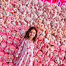 bear, bunny, child, colorful, curly_hair, cute, dress, floor, girl, happy, hello_kitty, indoor, neon_sign, pink, plush_toys, smiling, stuffed_animals, toy_display, wall, white