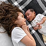 Enzo joined the competition — help win amazing prizes! child, baby, blanket, face, curly_hair, white_shirt, infant, lying_down, smiling, looking_at_each_other, indoors, cozy, family_moment, toddler, newborn, happy, skin, expression, closeup, bonding