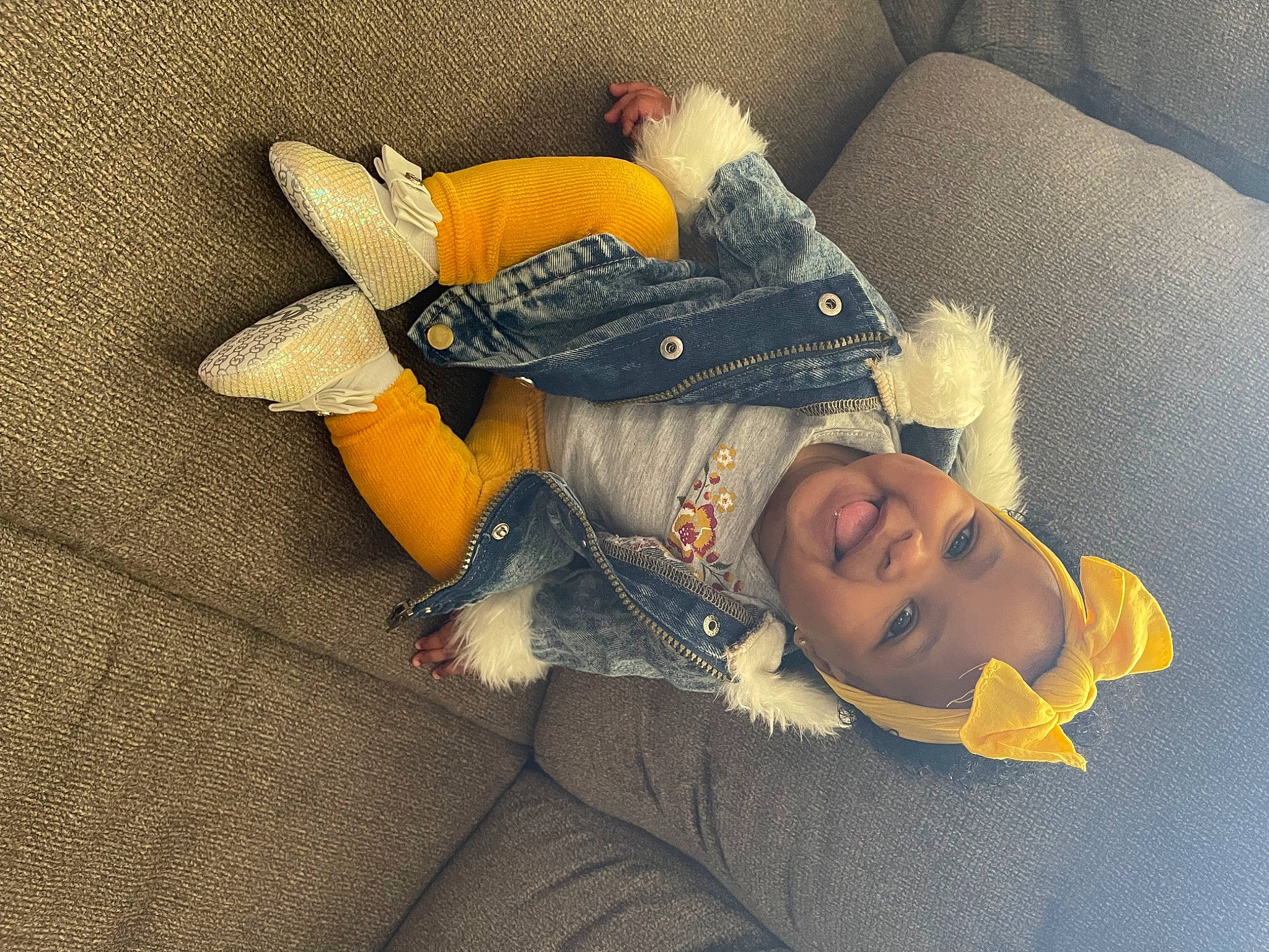 Imani is registered to the contest to win money with this photo: baby, baby_sleeping, child, comfort, couch, flooring, happy, human_body, lap, linens, orange, person, pillow, plush, sitting, smile, stuffed_toy, textile, toddler, toy