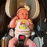 Lilie joined the competition — help win amazing prizes! baby, infant, child, car_seat, headband, flower, winnie_the_pooh, onesie, pink_clothing, sitting, lying_down, wide_eyes, face, smiling, indoor, vehicle, safety_harness, seat_belt, portrait, cute
