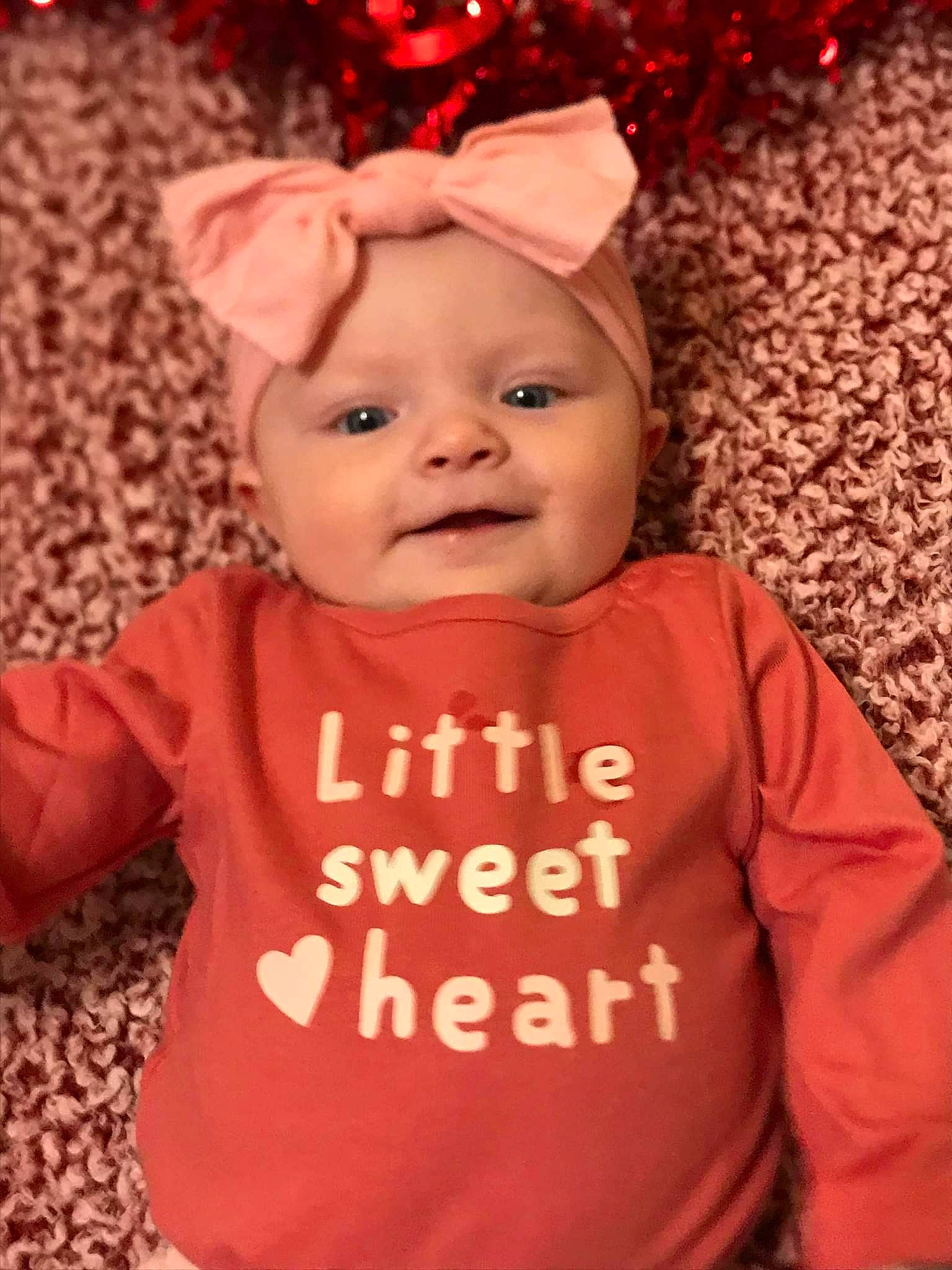 Avianna is registered to the contest to win money with this photo: baby, baby_toddler_clothing, cheek, child, costume_hat, facial_expression, fun, happy, head, headwear, human_body, organ, outerwear, people, person, pink, red, skin, sleeve, smile