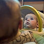 Stella joined the competition — help win amazing prizes! baby, candid, child, close_up, clothing, cozy, curious, expression, face, head, indoor, looking_up, mirror, person, portrait, reflection, soft_focus, warm_light, yellow_frame, young_child