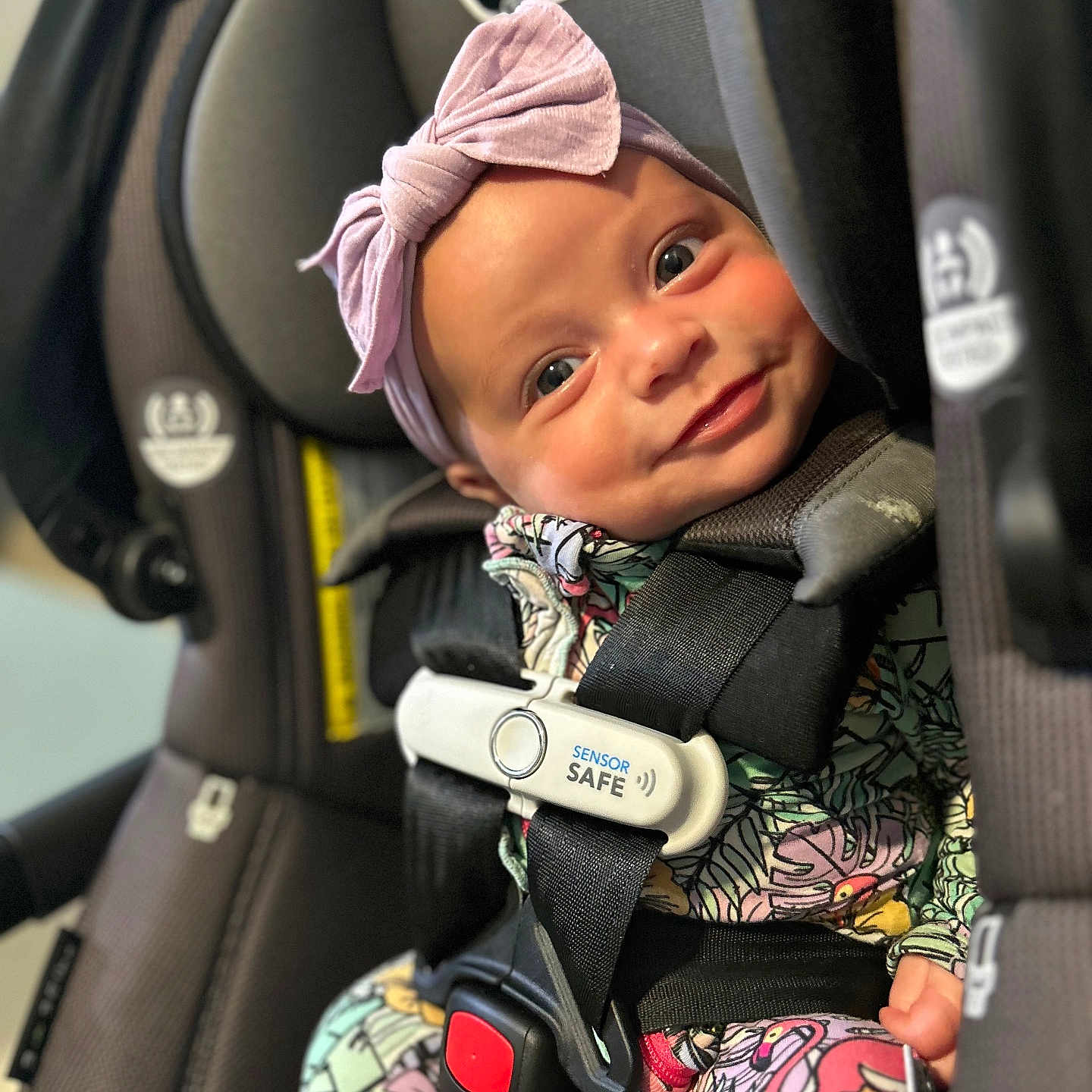 Baela joined the competition — help win amazing prizes! baby, car_seat, child, closeup, colorful, cute, face, floral_clothing, happy, headband, indoor, infant, person, pink, portrait, safety_harness, seat, seatbelt, sensor_safe, smiling