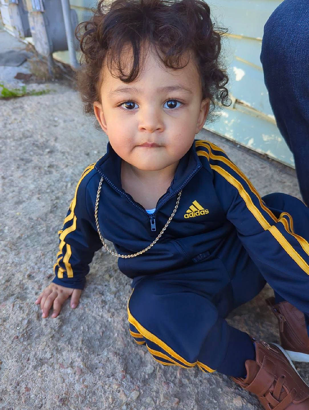 Giovanni is registered to the contest to win money with this photo: baby, baby_toddler_clothing, cheek, child, cool, electric_blue, eye, flooring, fun, grass, happy, person, sitting, sleeve, smile, soil, toddler, travel, vacation