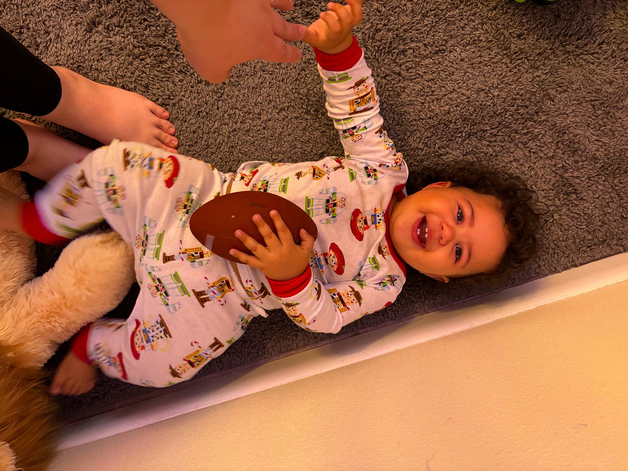 Gabriel is registered to the contest to win money with this photo: arm, baby, baby_toddler_clothing, barefoot, child, elbow, flooring, foot, fun, gesture, happy, human_leg, nail, pattern, person, sleeve, thigh, toddler, waist, wood