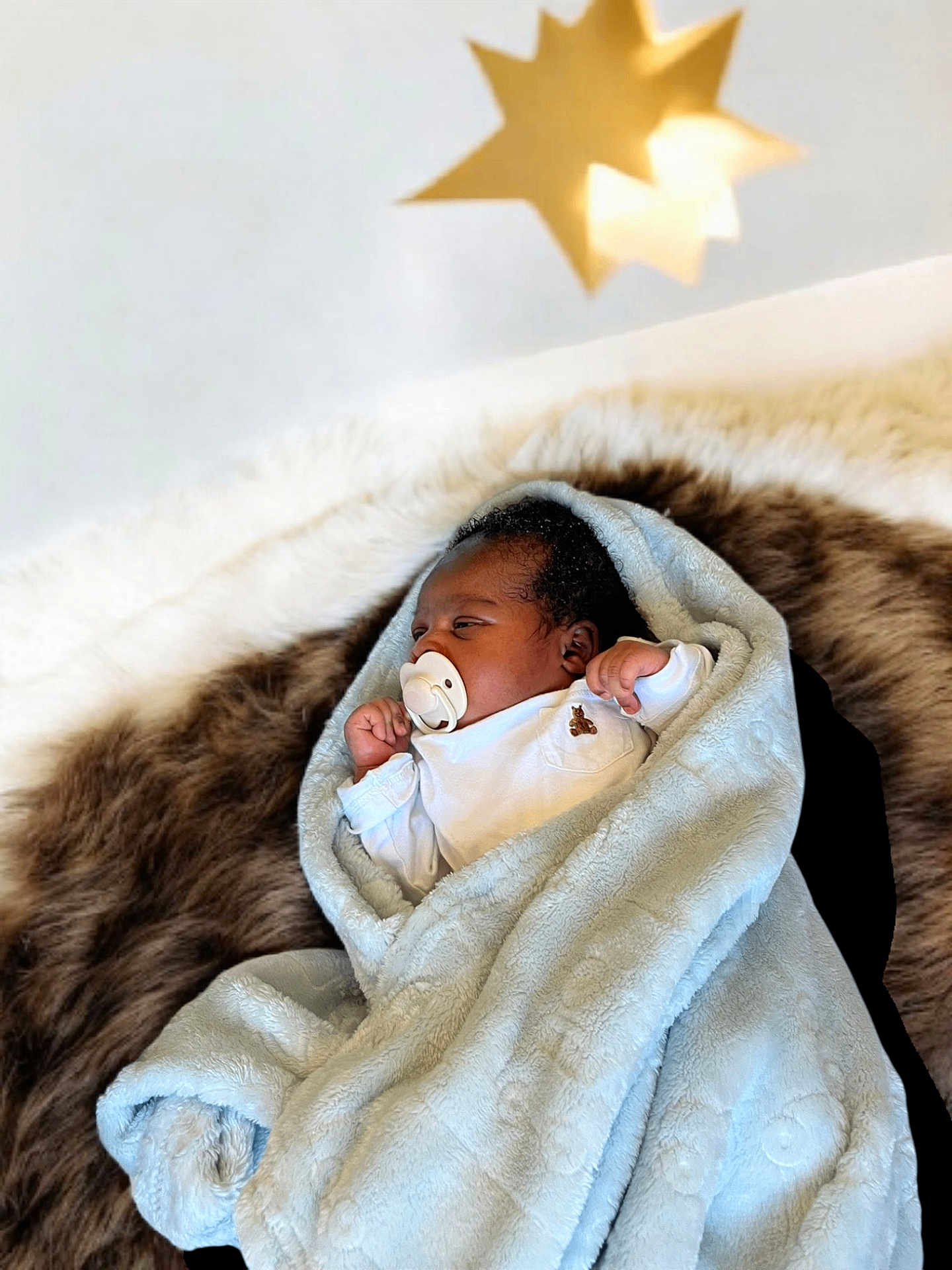 Boluwatife joined the competition — help win amazing prizes! baby, blanket, pacifier, fur, star, light, sleeping, infant, cozy, soft, white_clothing, portrait, indoors, resting, newborn, cute, wrapped, peaceful, baby_boy, comfort