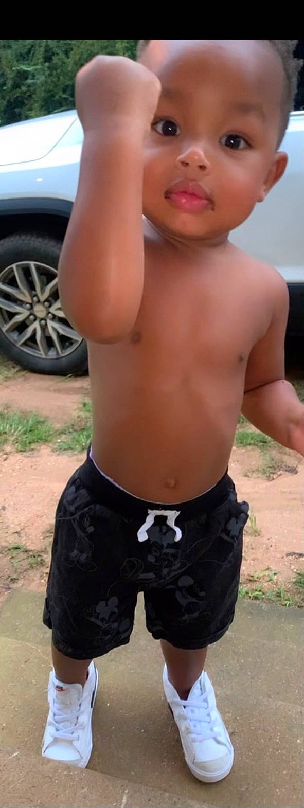 Harrison is registered to the contest to win money with this photo: abdomen, automotive_tire, barechested, black, car, chest, cool, hood, human, muscle, navel, person, photograph, thigh, tire, trunk, trunks, vehicle, waist, wheel