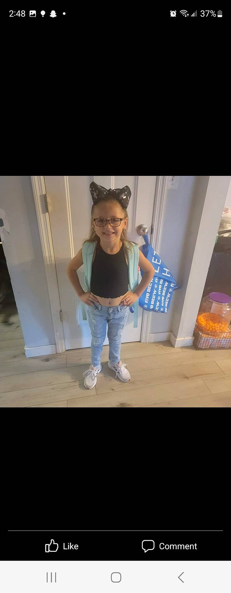 Aubry is registered to the contest to win money with this photo: denim, door, elbow, electric_blue, eyewear, flash_photography, floor, flooring, fun, glasses, happy, hardwood, human_leg, joy, knee, person, sleeve, t_shirt, thigh, toddler