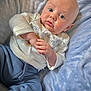 Elliott joined the competition — help win amazing prizes! baby, infant, blue_eyes, white_shirt, blue_pants, blanket, soft_texture, hands, clasped_hands, lying_down, cute, child, portrait, indoors, cozy, clothing, skin, head, face, expression