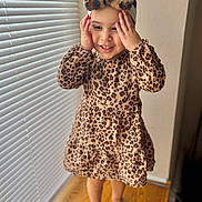 Eva joined the competition — help win amazing prizes! toddler, child, leopard_print, dress, headband, barefoot, standing, window_blinds, wood_floor, indoor, smiling, hands_on_face, playful, happy, cute, fashion, portrait, girl, soft_light, home