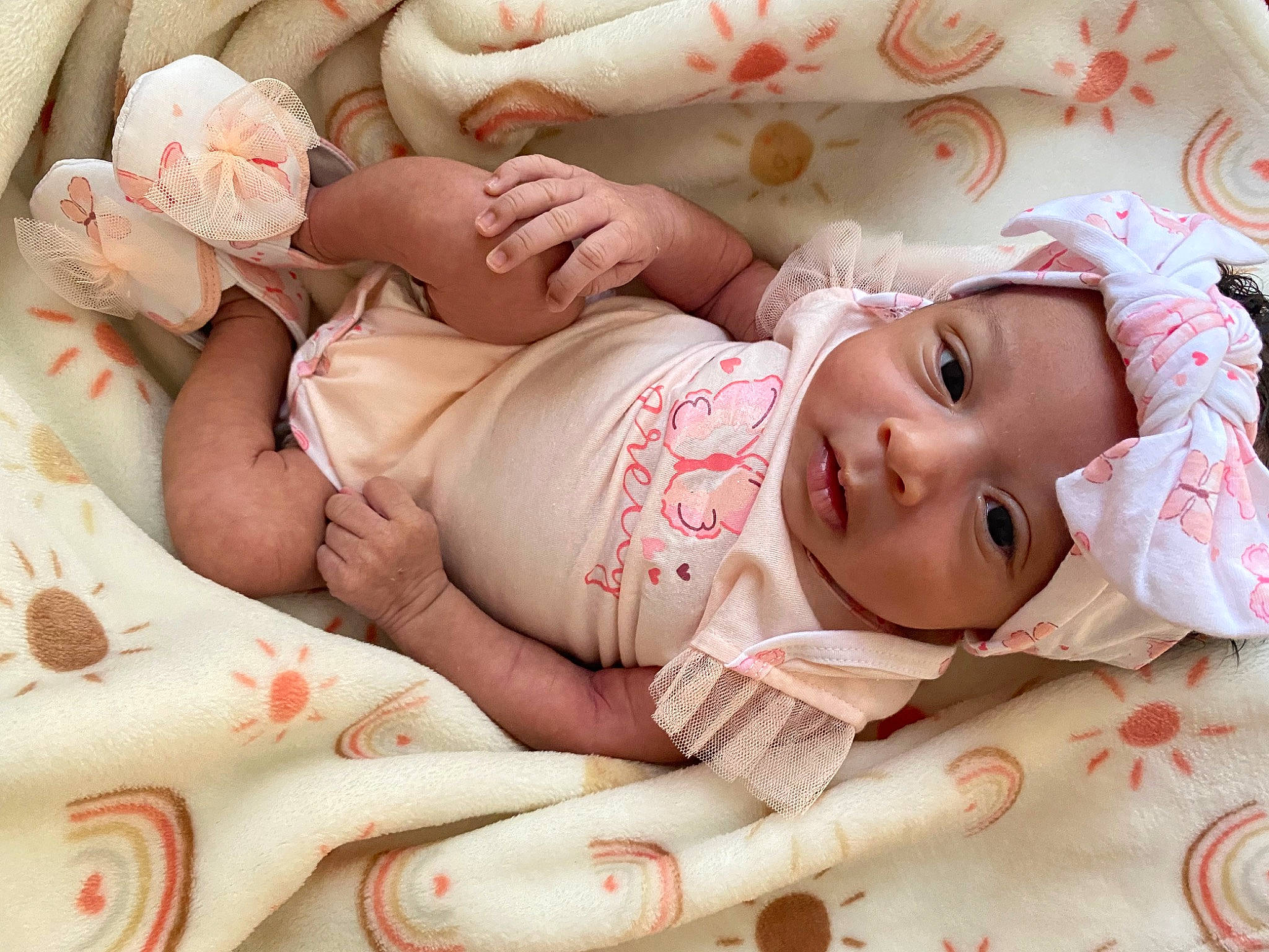 Kayoni is registered to the contest to win money with this photo: arm, baby, baby_toddler_clothing, cheek, chest, comfort, eye, face, finger, hand, headwear, human_body, linens, mouth, muscle, person, pink, skin, stomach, thigh