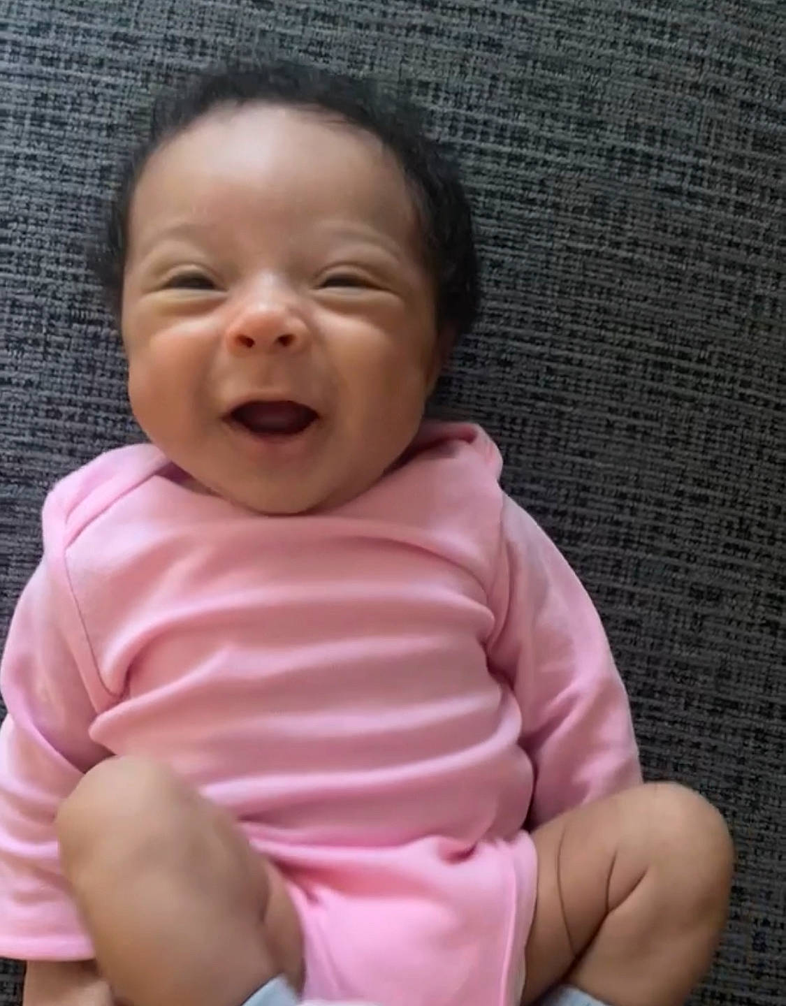 Kayoni is registered to the contest to win money with this photo: baby, baby_sleeping, baby_toddler_clothing, cheek, child, comfort, finger, fun, happy, laugh, lip, magenta, mouth, nose, person, pink, skin, sleeve, smile, thumb