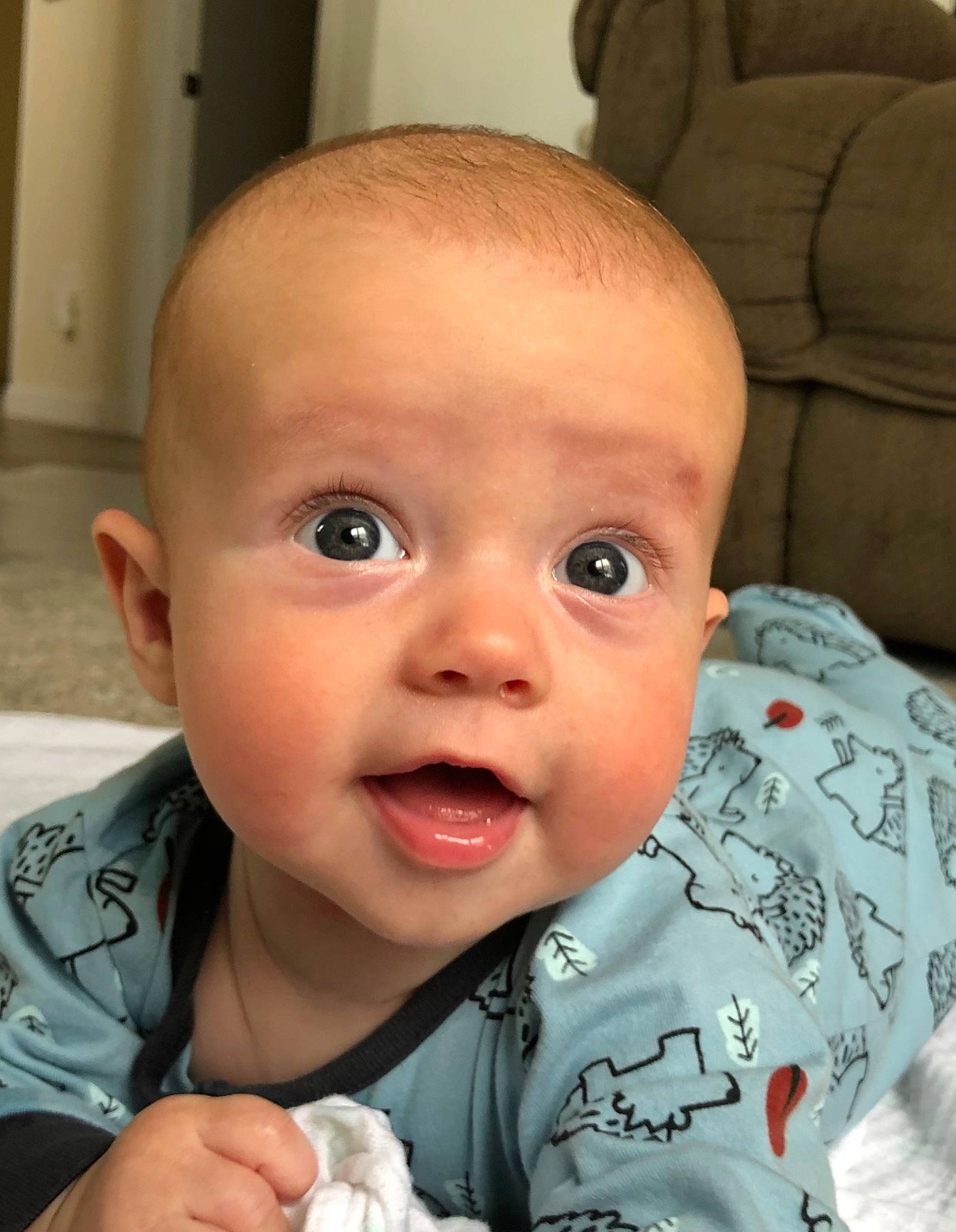 Robbie is registered to the contest to win money with this photo: baby, baby_toddler_clothing, cheek, chin, ear, eye, eyebrow, eyelash, face, facial_expression, gesture, head, iris, lip, mouth, nose, person, product, skin, sleeve