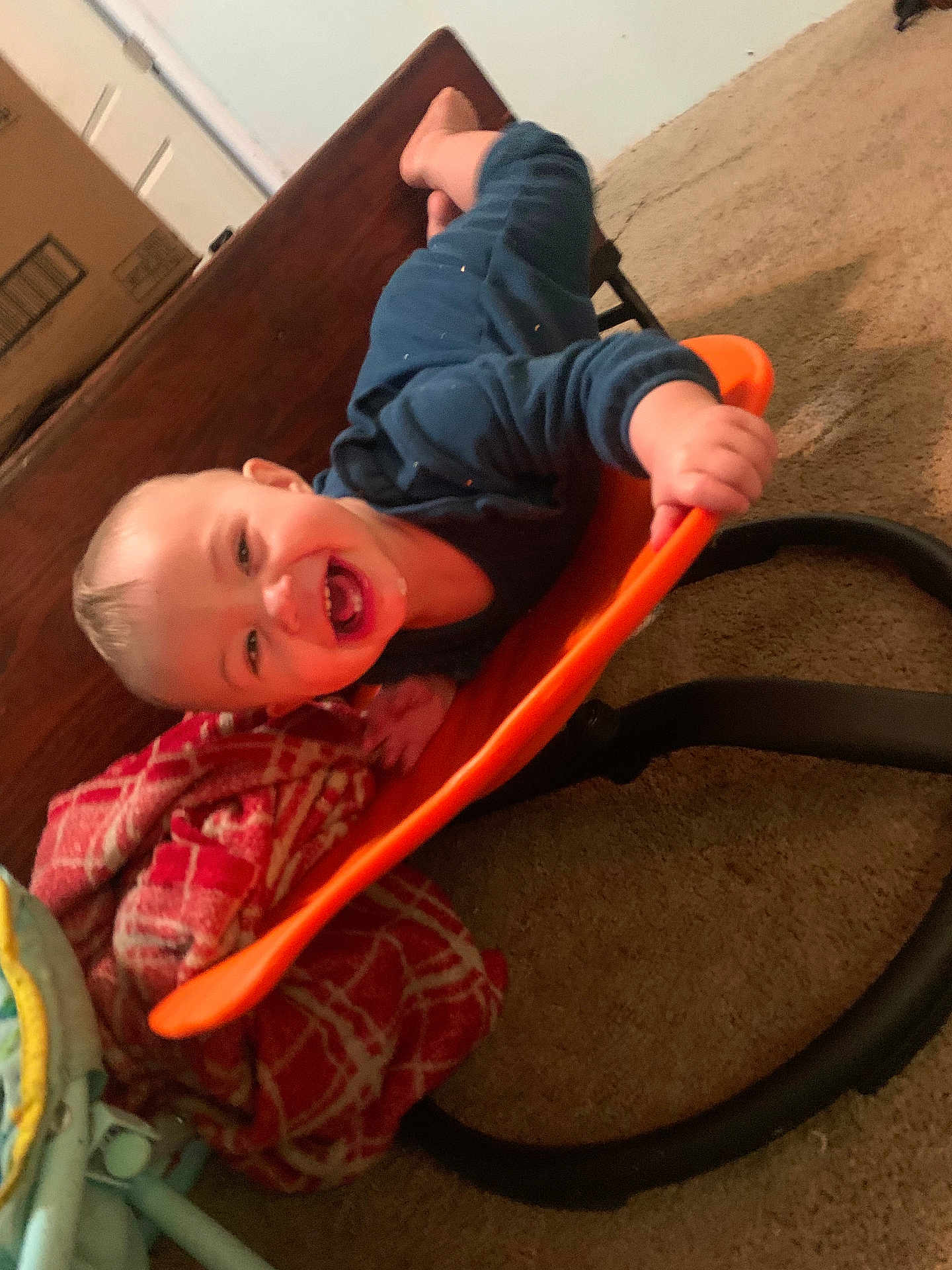 Maisie joined the competition — help win amazing prizes! toddler, child, smiling, laughing, baby_rocker, orange, blanket, carpet, indoor, playtime, happy, clothing, person, furniture, head, hand, foot, wood, fabric, baby