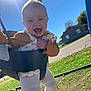 Maisie is registered to the contest to win money with this photo: baby, child, swing, outdoor, sunlight, happy, laughing, grass, playground, blue_sky, house, clothing, tights, joy, daylight, fun, person, nature, smile, park