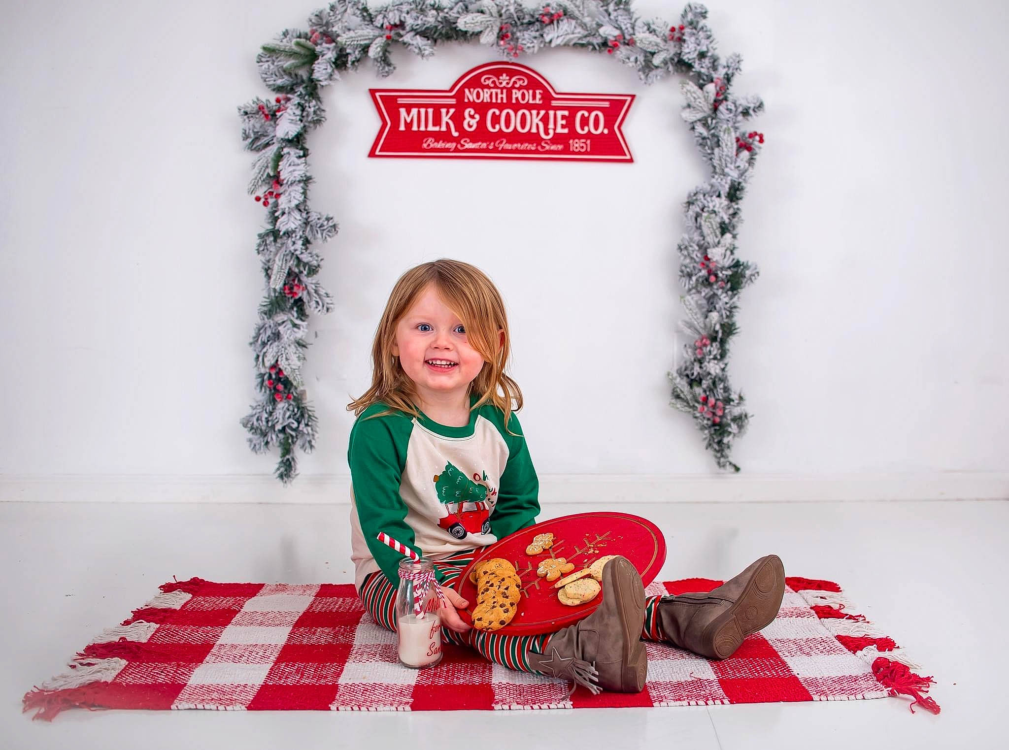Baylee is registered to the contest to win money with this photo: baby_toddler_clothing, christmas, christmas_decoration, christmas_eve, christmas_ornament, design, event, face, flooring, happy, holiday, joy, ornament, pattern, person, picture_frame, red, sleeve, smile, tartan