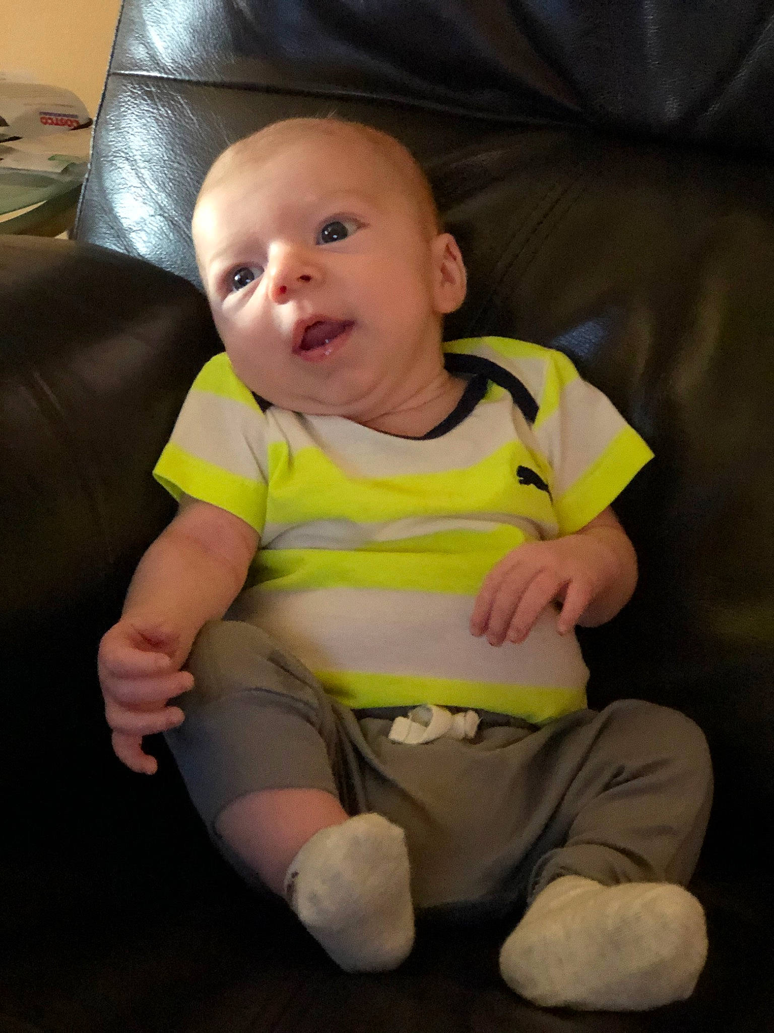 Wylie is registered to the contest to win money with this photo: baby, cheek, child, eye, face, facial_expression, finger, fun, happy, head, mouth, nose, person, sitting, skin, smile, t_shirt, toddler, yellow