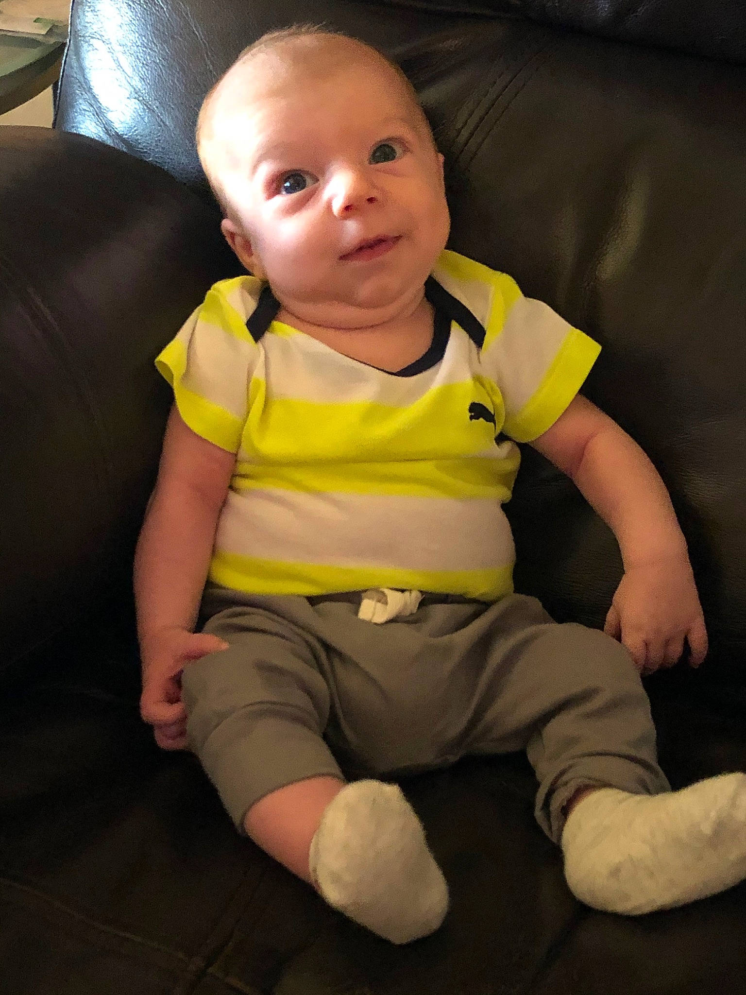 Wylie is registered to the contest to win money with this photo: arm, baby, cheek, child, fun, head, leg, person, sitting, skin, smile, standing, t_shirt, toddler, yellow