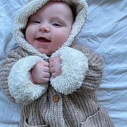 Robyn joined the competition — help win amazing prizes! baby, blanket, button, child, cozy, cute, face, fuzzy, hands, happy, hood, indoor, infant, knitwear, lying_down, portrait, small_fingers, smiling, soft_texture, warm_clothing