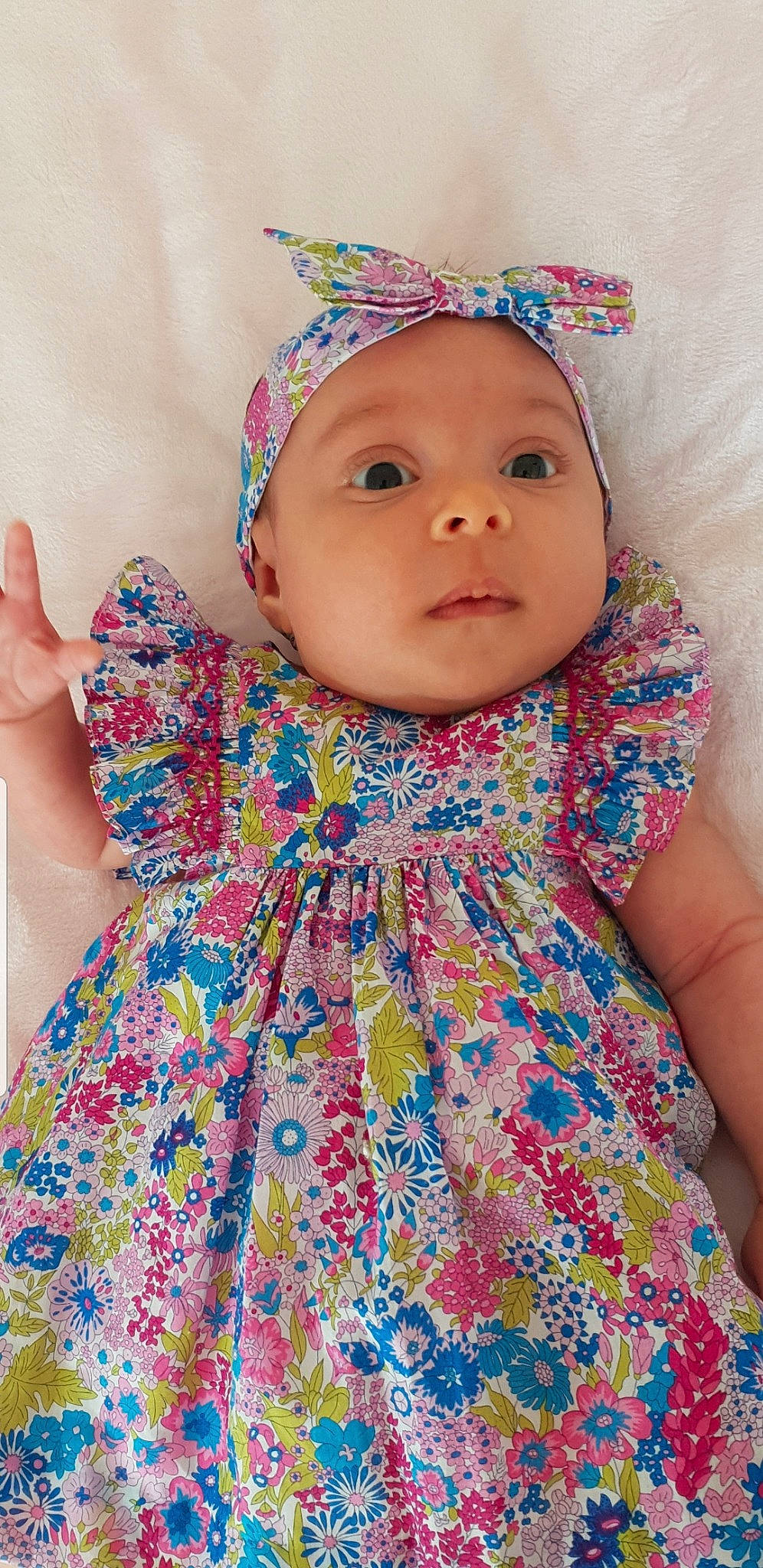 Lyla participe au concours pour gagner de l'argent avec cette photo : aqua, azure, baby_toddler_clothing, blue, clothing, day_dress, dress, face, facial_expression, fashion, happy, headwear, lip, neck, one_piece_garment, organ, outerwear, person, pink, skin