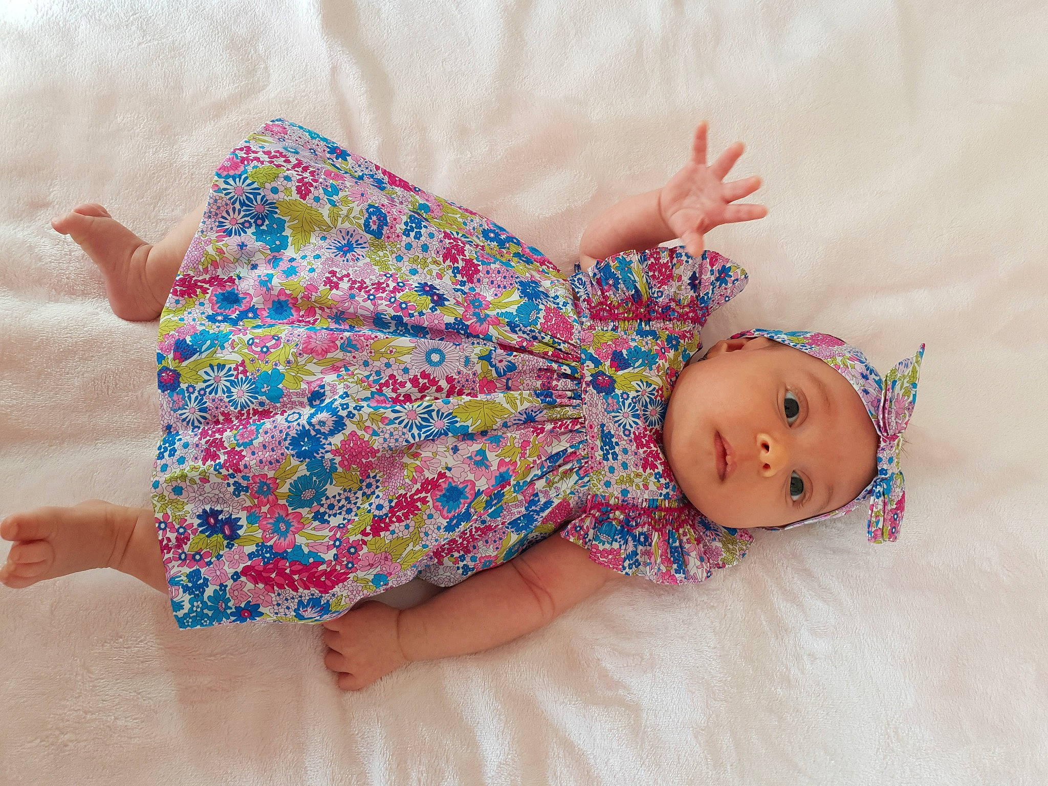 Lyla participe au concours pour gagner de l'argent avec cette photo : baby, baby_toddler_clothing, child, comfort, creative_arts, dress, finger, happy, headgear, headwear, human_body, leg, linens, nail, pattern, person, pink, skin, sleeve, textile
