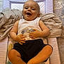 baby, smiling, infant, changing_pad, towel, floor_tile, baby_clothing, pacifier, baby_brush, happy, person, child, indoor, cute, legs, hands, head, face, jeans, playful
