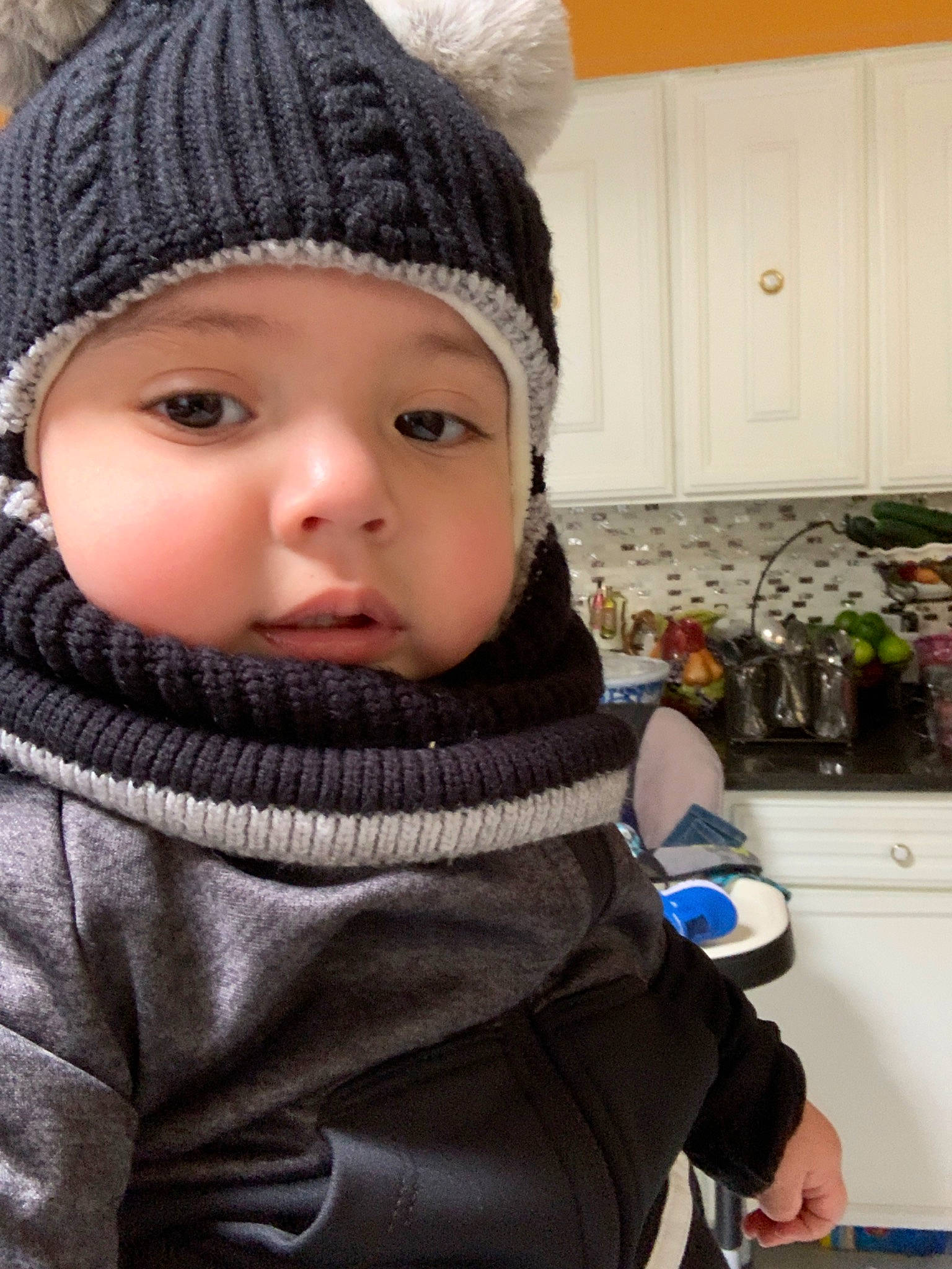 Lionel is registered to the contest to win money with this photo: baby, beanie, bonnet, cap, cheek, child, clothing, fashion_accessory, headgear, headwear, knit_cap, person, toddler, winter, wool