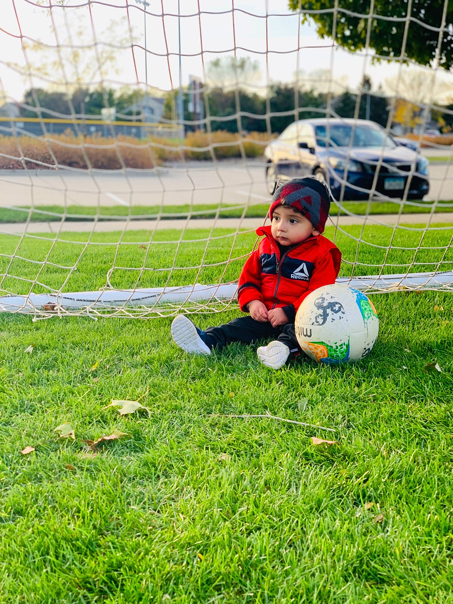 Lionel is registered to the contest to win money with this photo: ball, ball_game, child, competition_event, football, fun, goalkeeper, grass, lawn, net, person, play, player, recreation, soccer, soccer_ball, sports, sports_equipment, team, team_sport
