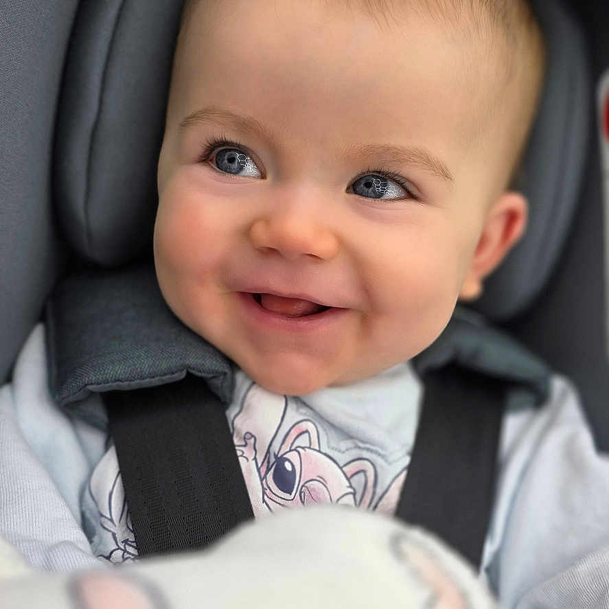 Ayla is registered to the contest to win money with this photo: baby, baby_girl, blanket, blue_eyes, car_seat, child, clothing, cozy, cute, face, happy, head_support, indoors, infant, pacifier, portrait, seatbelt, smile, soft_toys, warm