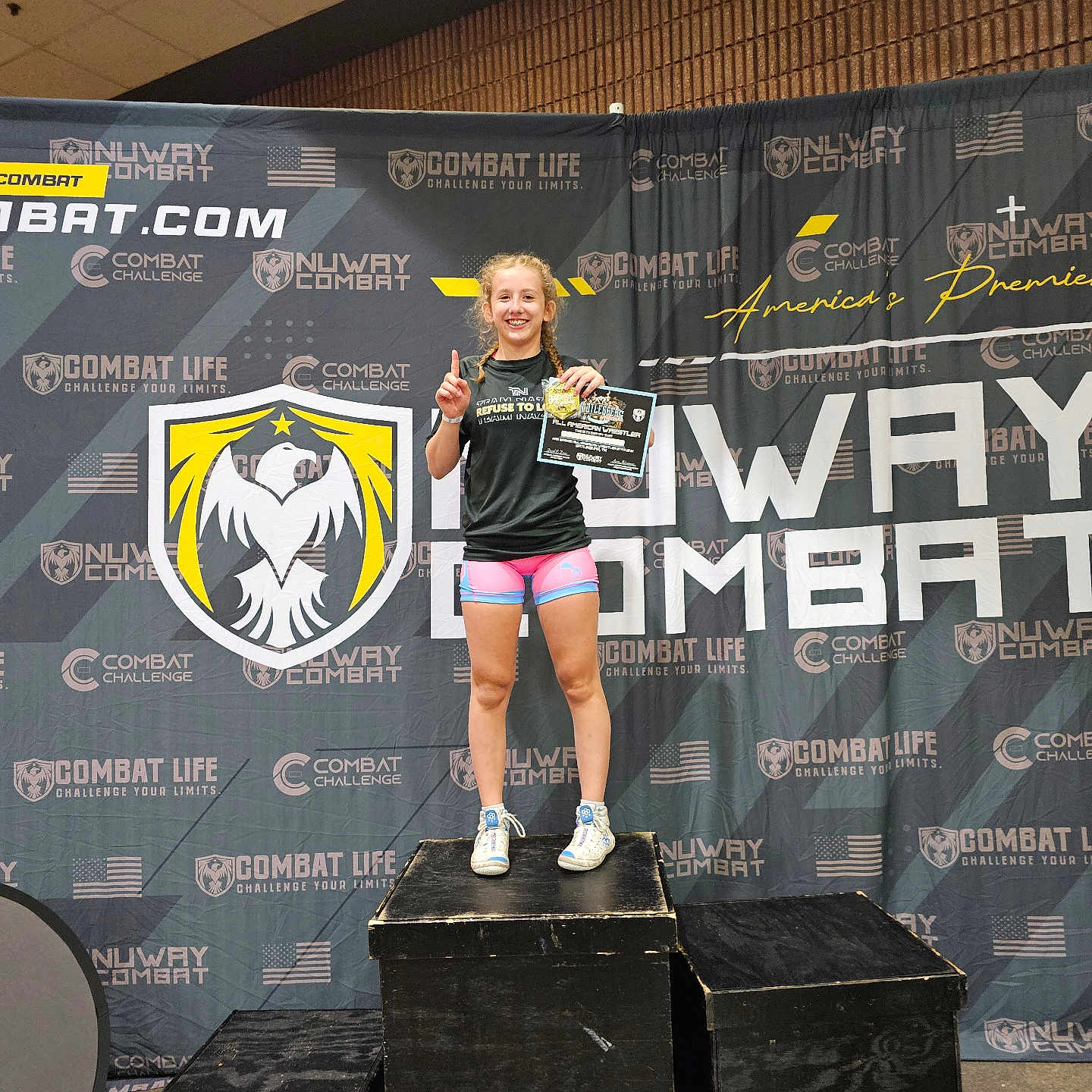 Aubrie is registered to the contest to win money with this photo: accessories, adult, box, bracelet, clothing, crowd, face, female, footwear, head, jewelry, pants, performer, person, shoe, shorts, soloperformance, stage, t_shirt, woman