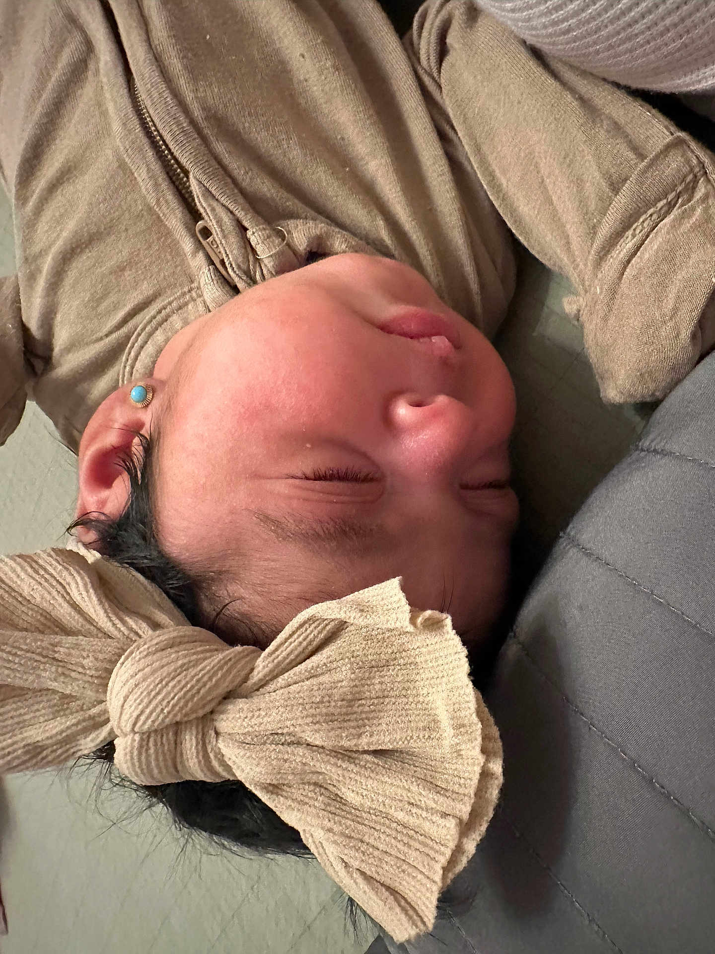 Mar is registered to the contest to win money with this photo: baby, headband, bow, sleeping, face, earring, clothing, soft, infant, child, cute, resting, indoors, portrait, closeup, skin, young, peaceful, head, person