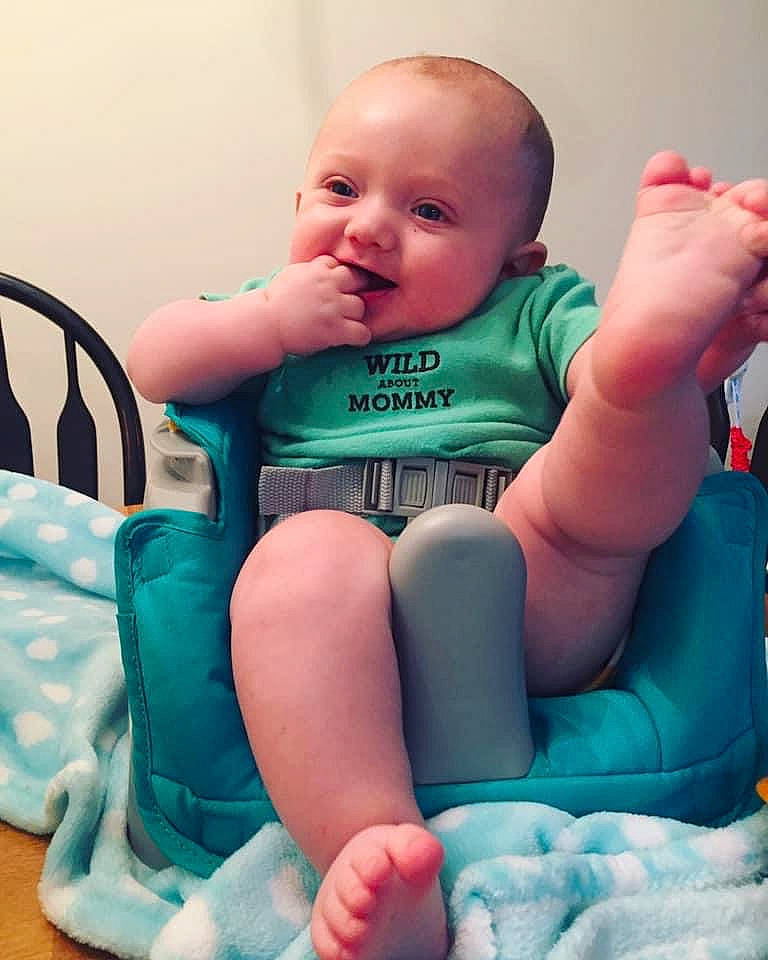Emmitt is registered to the contest to win money with this photo: arm, baby, baby_toddler_clothing, blue, cheek, child, finger, leg, person, sitting, skin, sole, thumb, toddler