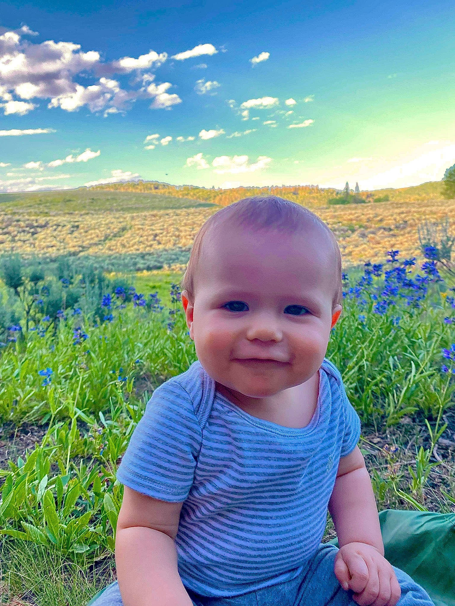 Kaison is registered to the contest to win money with this photo: azure, baby, baby_toddler_clothing, blue, cloud, flower, grass, green, happy, joy, leaf, light, nature, people_in_nature, person, photograph, plant, skin, sky, smile