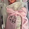 newborn, baby, sleeping, swaddled, hospital_bassinet, blanket, bow, pink, striped, infant, face, peaceful, hospital, crib, person, cute, resting, soft, decorations, monogram
