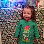 Diana Pille a rejoint le concours — aidez-le/la à gagner de superbes lots ! background, child, christmas, decorations, face, festive, floor, green, happy, holiday, indoor, lights, pajamas, pattern, person, plush_toy, red, smiling, toy, tree