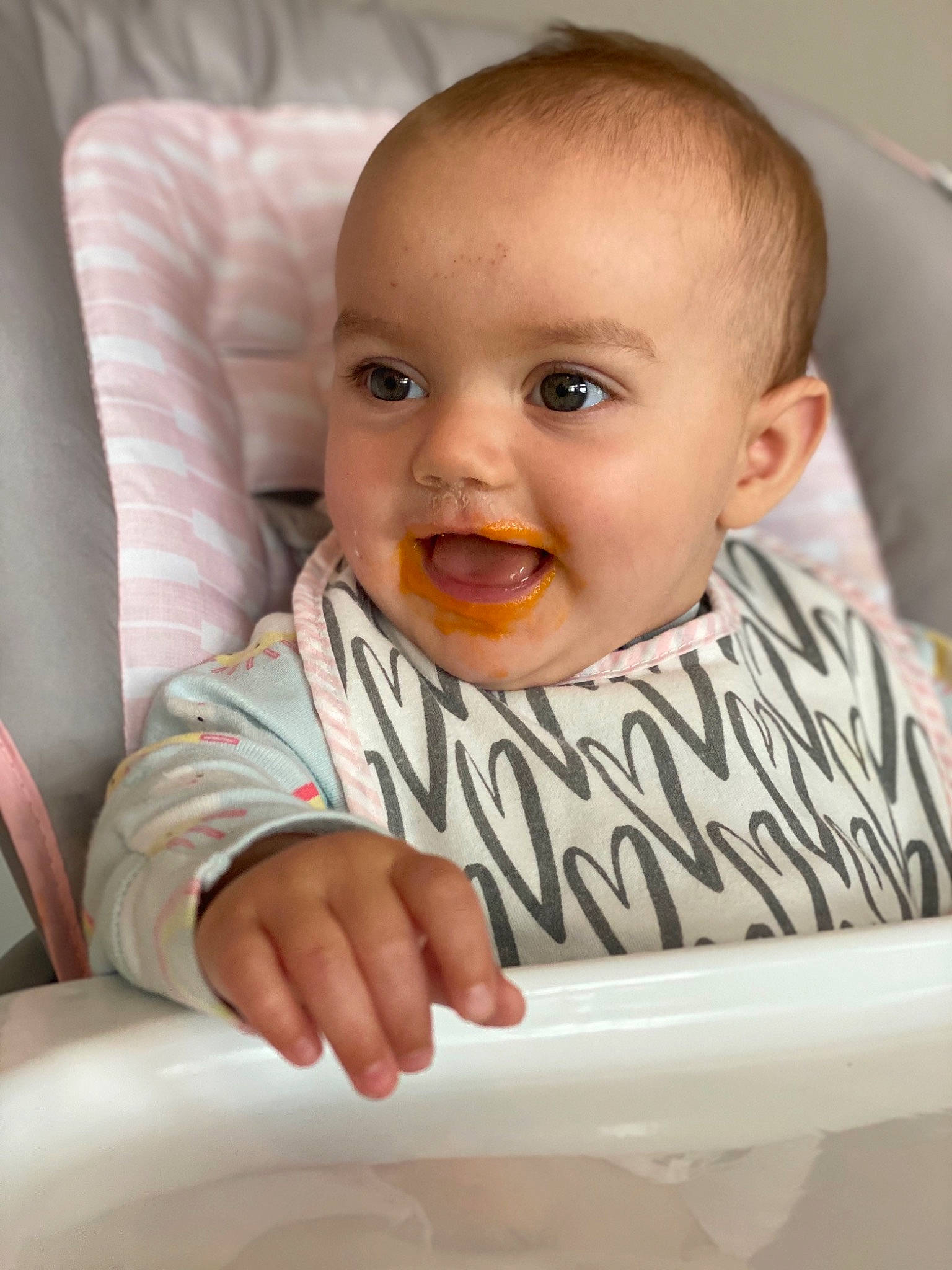 Wren is registered to the contest to win money with this photo: arm, baby_toddler_clothing, cheek, chin, comfort, eye, eyebrow, gesture, happy, head, iris, lip, mouth, nose, person, product, sleeve, smile, standing, t_shirt