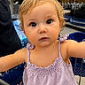toddler, child, shopping_cart, purple_top, blonde_hair, curious_expression, indoor, store, retail, person, face, eyes, arm, clothing, baby, young_child, cute, shopping, seat, metal_bar