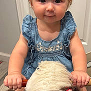 Charleigh is registered to the contest to win money with this photo: toddler, child, plush_toy, rocking_horse, blue_dress, headband, indoor, flooring, wooden_floor, cute, smiling, baby, toy, person, young_child, portrait, holding, playtime, happy, decor