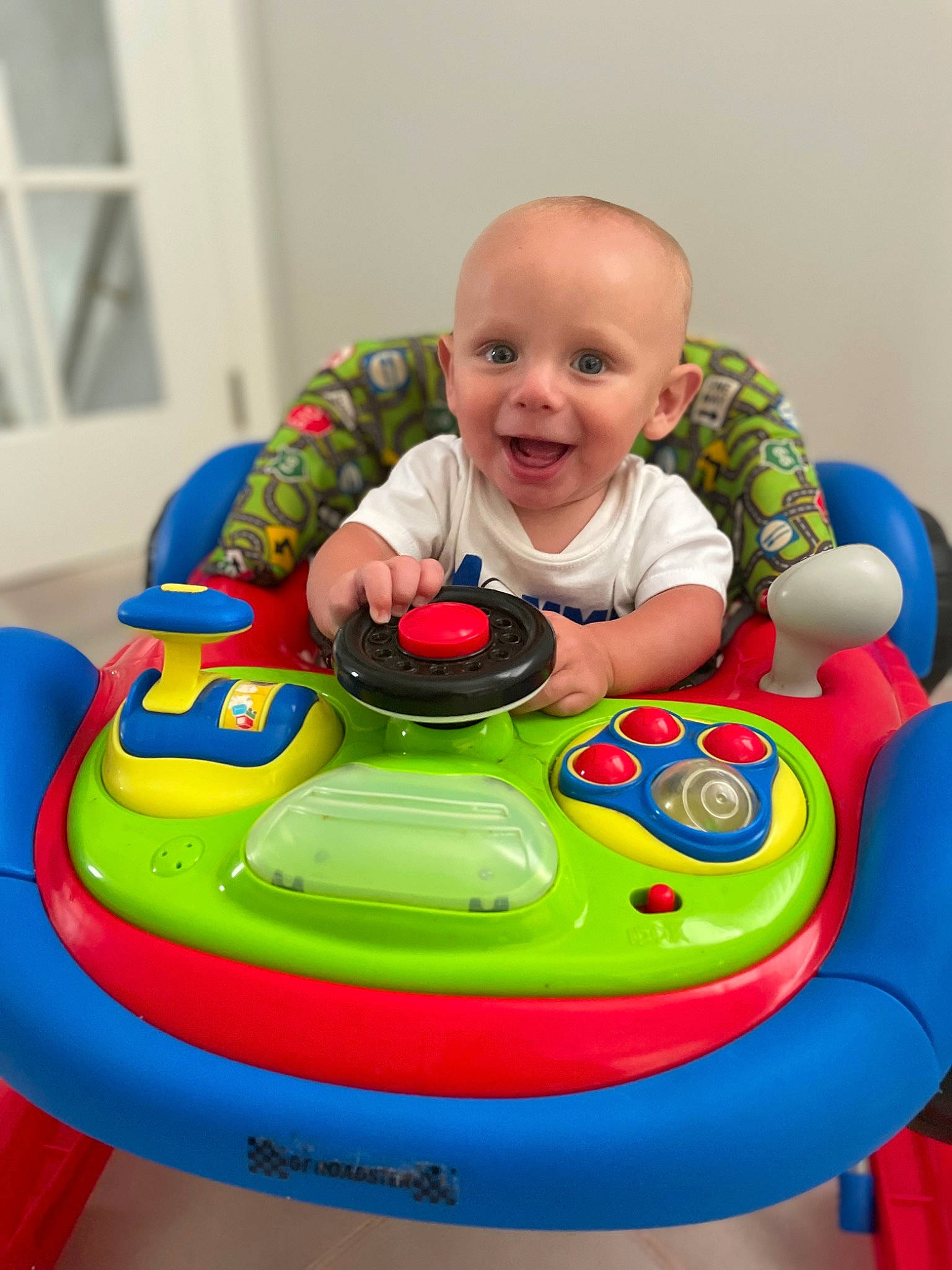 Cayden is registered to the contest to win money with this photo: arm, baby, baby_playing_with_toys, baby_products, baby_toddler_clothing, eye, facial_expression, fun, happy, head, leisure, person, product, recreation, red, riding_toy, skin, smile, toddler, toy
