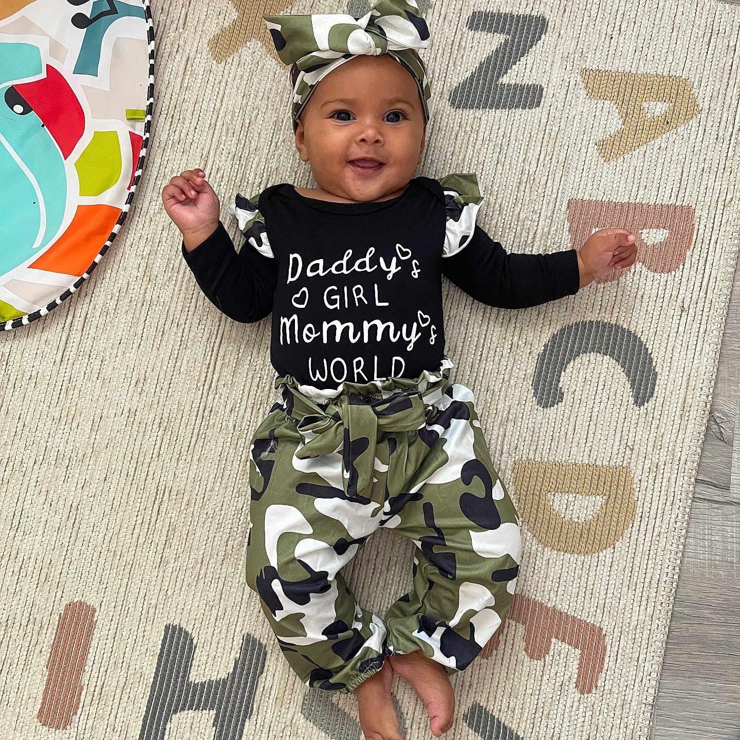 Kendall joined the competition — help win amazing prizes! baby, babylaughing, bodypart, clothing, face, happy, hat, head, homedecor, mat, number, pants, person, photography, portrait, sitting, sleeve, standing, symbol, text