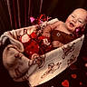 Onyx joined the competition — help win amazing prizes! baby, blanket, teddy_bear_prints, couch, heart_shapes, smiling, happy, infant, cozy, indoor, child, soft_toys, wrapped, cute, red, pink, brown, furniture, portrait, relaxed
