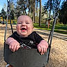 baby, child, swing, playground, outdoor, smiling, happy, park, trees, sunny, daylight, clothing, seat, metal, chain, woods, nature, fun, cute, person