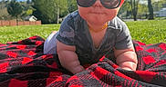 Onyx joined the competition — help win amazing prizes! baby, child, sunglasses, blanket, outdoor, grass, sunny, daytime, trees, nature, camouflage, shirt, smile, face, head, person, cute, plaid, recreation, relaxation